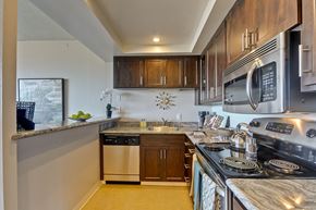 Palo Alto apartment for rent - a kitchen with stainless steel appliances and wooden cabinets