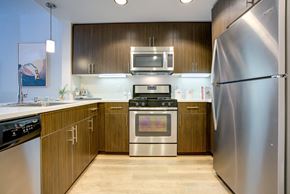 San Jose apartment for rent - a kitchen with stainless steel appliances and wooden cabinets