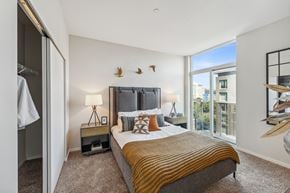 Seattle apartment for rent - a bedroom with a large bed and a large window