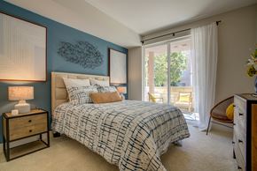 San Jose apartment for rent - a bedroom with a bed and a sliding glass door to a balcony