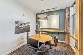 Seattle apartment for rent - a dining room with a table and chairs and a large window