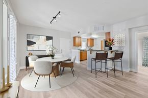 Pleasanton apartment for rent - A modern dining room with a white table and chairs.