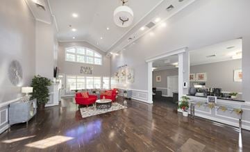 Alexandria apartment for rent - A spacious living room with a red couch and a wooden floor.