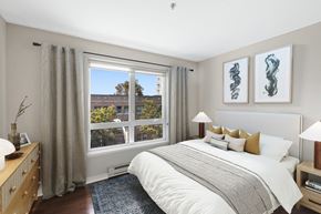 Seattle apartment for rent - a bedroom with a large bed and a large window