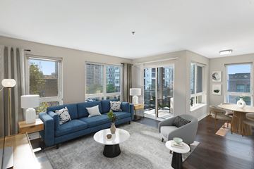 Seattle apartment for rent - a living room with a blue couch and a gray rug