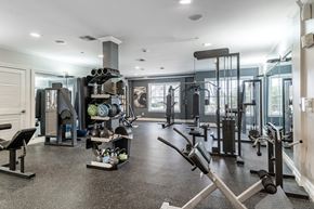 Salem apartment for rent - a home gym with weights and cardio equipment and a window