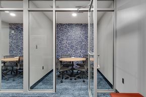 Medford apartment for rent - a small meeting room with glass walls and a blue tiled wall in the background