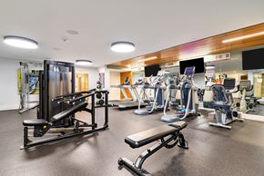 Seattle apartment for rent - A gym with a variety of equipment including treadmills, weights, and exercise machines.