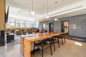 Seattle apartment for rent - A modern dining room with a long wooden table and black chairs.