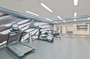 Morristown apartment for rent - a gym with exercise equipment and a wall mural of a soccer field