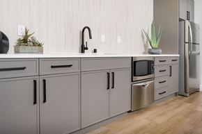 Sunnyvale apartment for rent - A kitchen with grey cabinets and a wooden floor.