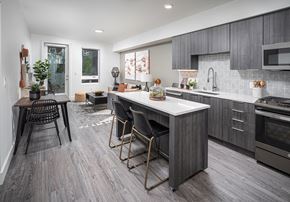 Milpitas apartment for rent - a kitchen with a large island and a table with chairs