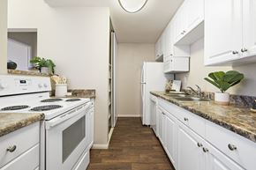 San Diego apartment for rent - a spacious kitchen with white appliances and white cabinets