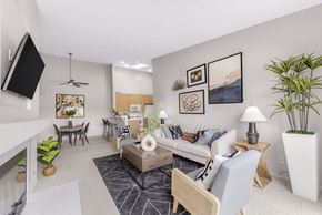 San Diego apartment for rent - A living room with a white couch, a coffee table, and a television.