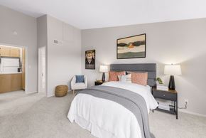 San Diego apartment for rent - A bedroom with a large bed and a painting on the wall.