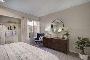 Thousand Oaks apartment for rent - a bedroom with a bed and a dresser with a mirror