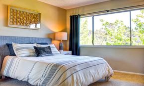 Belmont apartment for rent - a bedroom with a bed and a large window