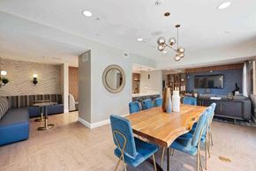 Woodland Hills apartment for rent - a dining room with a wooden table and blue chairs