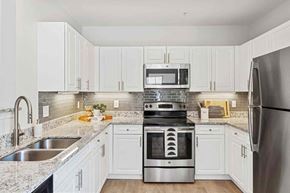 Salem apartment for rent - a kitchen with white cabinets and stainless steel appliances