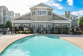 Danvers apartment for rent - A large building with a pool in front of it.