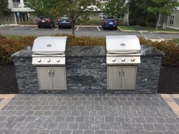 Outdoor barbecue grilling stations with picnic area