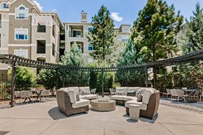 Centennial apartment for rent - a patio with couches and tables in front of an apartment building
