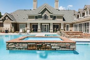 Centennial apartment for rent - a large swimming pool in front of a house