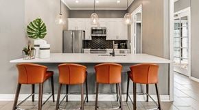 Centennial apartment for rent - a kitchen with a counter and four orange chairs