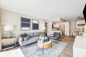 Simi Valley apartment for rent - A modern living room with a grey sofa, a wooden coffee table, and a grey rug.