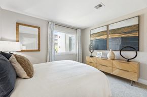 Simi Valley apartment for rent - A bedroom with a large bed and a wooden dresser.