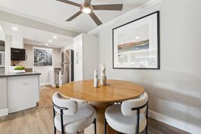 Simi Valley apartment for rent - A modern dining room with a round wooden table and grey chairs.