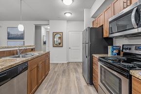Hillsboro apartment for rent - a kitchen with stainless steel appliances and wooden cabinets