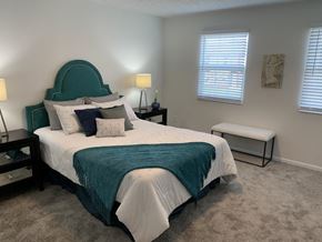 Columbus apartment for rent - a bedroom with a bed and a chair and a window
