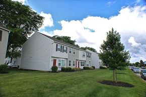 Columbus apartment for rent - a row of houses with a tree in the yard