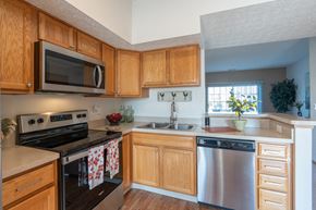 Grove City apartment for rent - A kitchen with wooden cabinets and a stainless steel dishwasher.