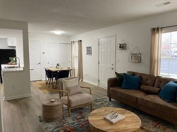 Grove City apartment for rent - A living room with a brown couch and a wooden coffee table.