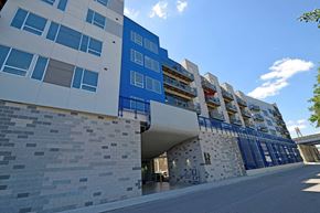 Newport apartment for rent - a large blue building with a street in front of it