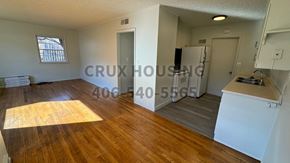 Havre apartment for rent - A room with wooden floors and white walls, with a window on the left side.