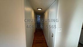 Havre apartment for rent - A hallway with a number and a company name on the wall.