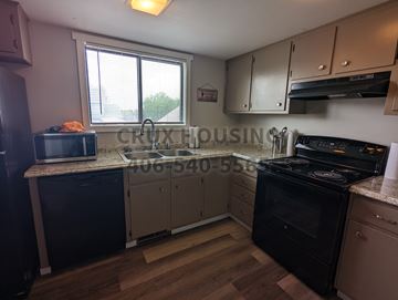 Great Falls apartment for rent - A kitchen with wooden floors and a stove top oven.