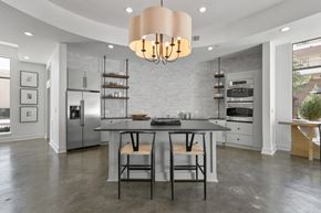 Farmers Branch apartment for rent - a kitchen with a large island with two stools and a stainless steel refrigerator