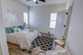 Oakwood apartment for rent - a bedroom with a bed and a ceiling fan