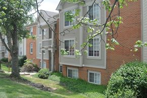 Ft Mitchell apartment for rent - A tree is in front of a building with a red brick wall.