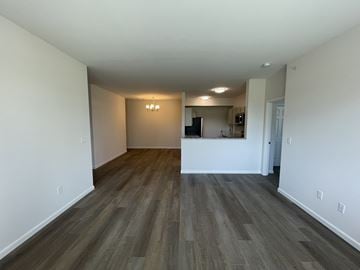 Hebron townhouse for rent - A room with a kitchen area in the background.