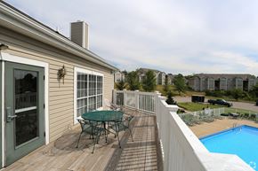Alexandria apartment for rent - A house with a deck and a table and chairs on it.