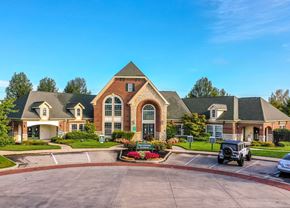 Mason apartment for rent - A large, well-maintained building with a driveway in front at Twin Fountains Apartments, Mason, 45040