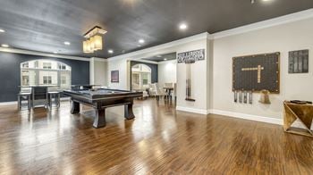 A game room with a pool table and a bar