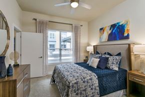 Beachwood apartment for rent - a bedroom with a bed and a ceiling fan at Aster Apartments, Beachwood, 44122