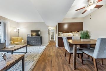 Maryland Heights apartment for rent - a living room with a dining room table and a tv