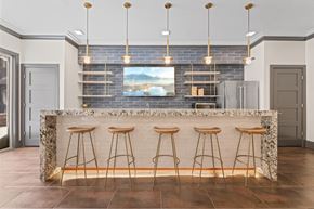 Beachwood apartment for rent - A kitchen with a bar area featuring a granite counter and bar stools at Aster Apartments, Beachwood, OH 44122